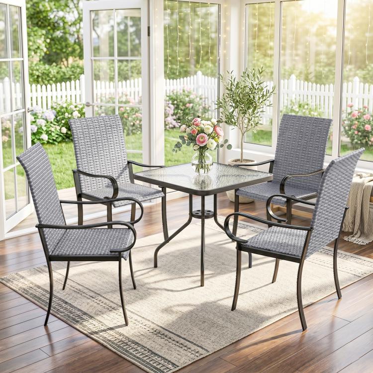 Indoor-outdoor dining set with four gray wicker chairs around a round table