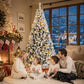Snow-flocked prelit Christmas tree with warm white lights, slim profile on stand