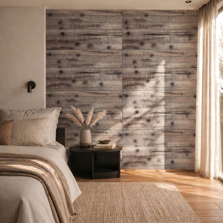 Gray faux wood plank wall paneling beside a bed and window curtains.