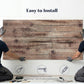 Gray faux wood wall panel held by installers for mounting on a wall.