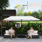 Beige patio umbrella open with central pole and weighted base, over patio seating