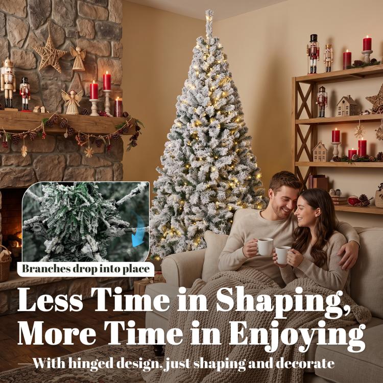 Snow-flocked prelit Christmas tree with dense branches and hinged design.