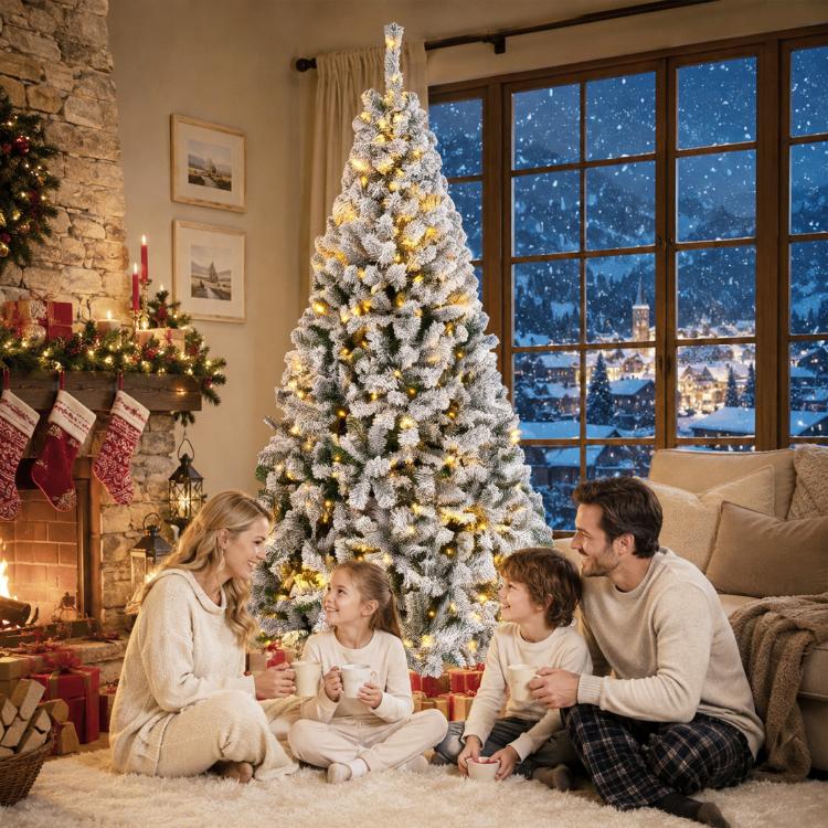 Snow-flocked prelit Christmas tree with full conical shape and warm lights, standing upright.