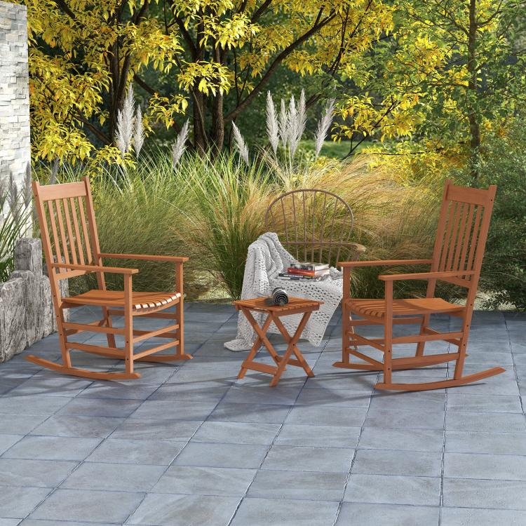 Outdoor rocking chair set of 2 with side table and slatted seats in warm wood tone