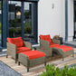 Brown wicker lounge chairs with red seat pads and two ottomans on a patio