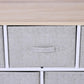 Close-up of light gray fabric drawer with handle under wood top, white frame.