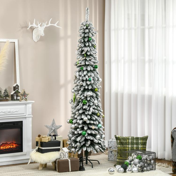 Snow-frosted slim pencil artificial Christmas tree with visible green ornaments and black stand
