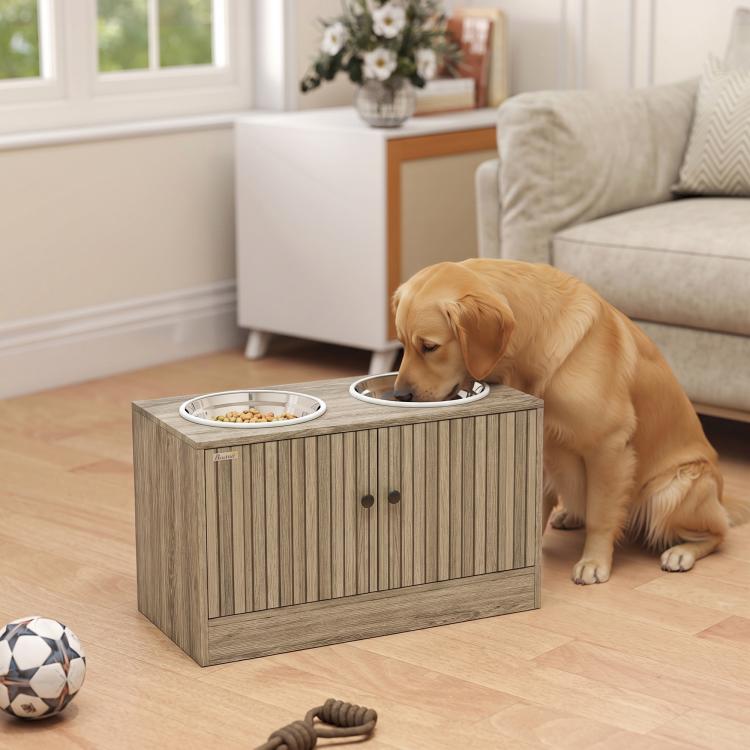 Elevated dog feeding station with two stainless bowls and storage cabinet, with dog