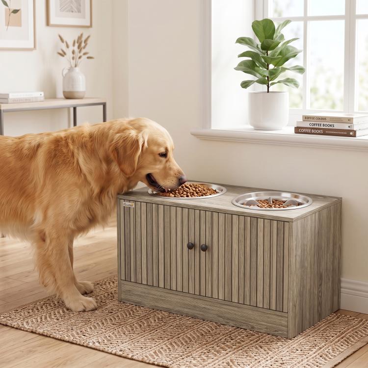 Dog eating from the left stainless bowl on a wood-grain elevated feeding station