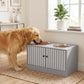 Golden dog eating from raised bowls on a gray dog feeding station cabinet