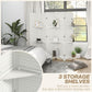 White folding room divider with multiple shelves behind a bed and gray bedding.