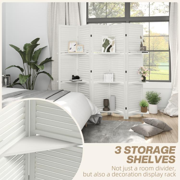 White folding room divider with multiple shelves behind a bed and gray bedding.