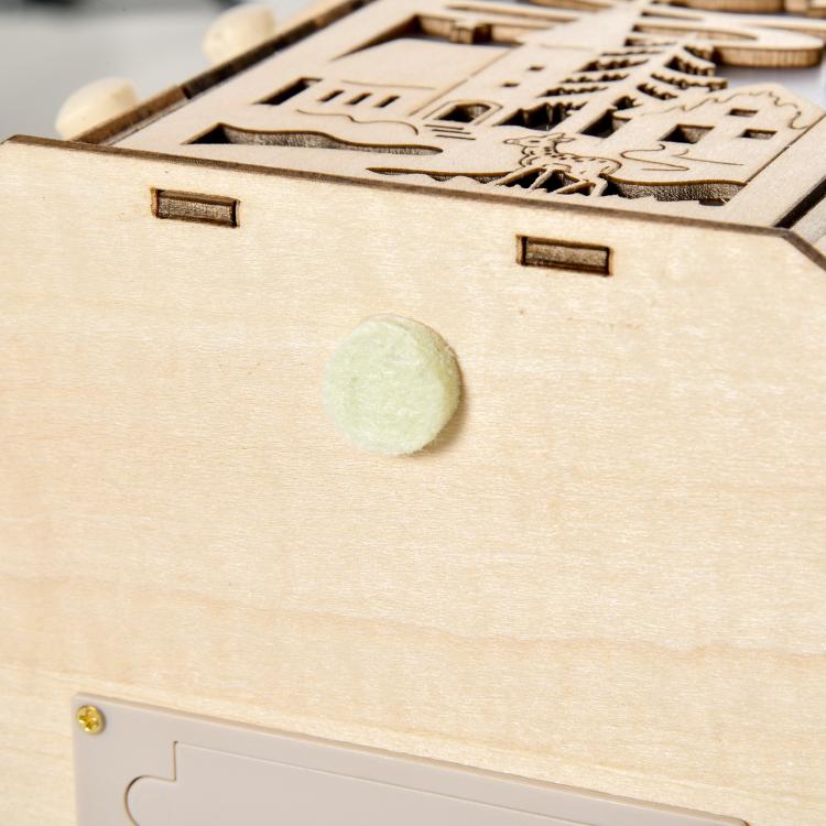 Natural wooden advent calendar front panel with small drawer opening and engraved design