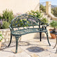Green decorative metal bench with curved scroll back and rose rosette accents