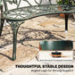 Green bench with openwork seat and angled legs with protective footpads