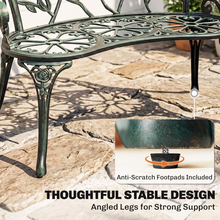 Green bench with openwork seat and angled legs with protective footpads