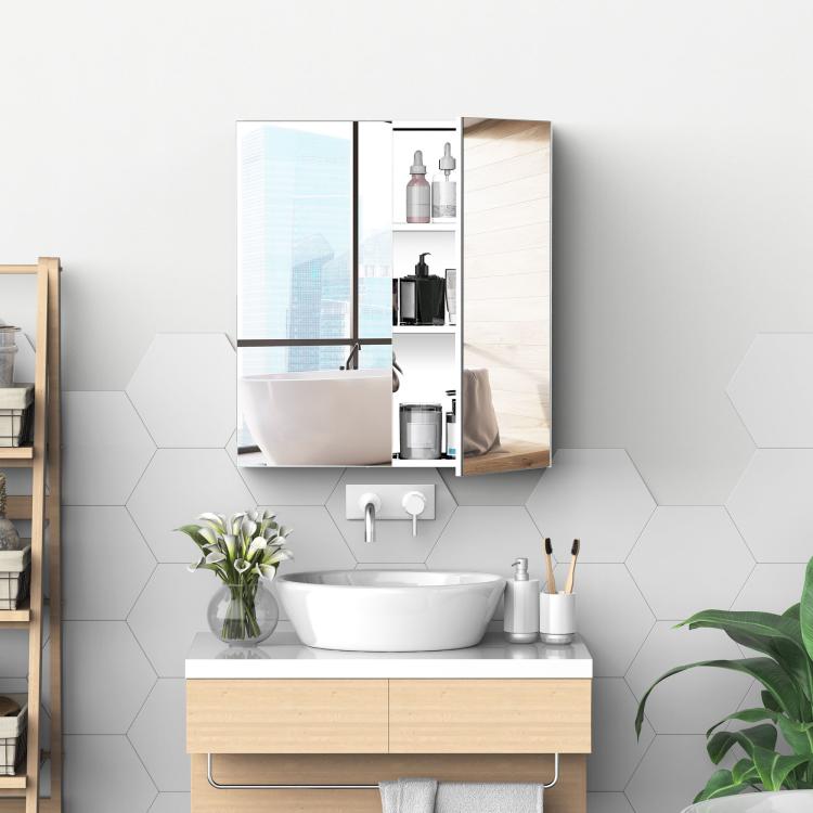 Wall-mounted mirrored medicine cabinet above sink with two reflective door panels.