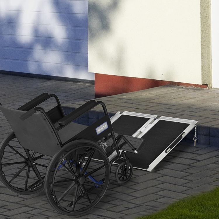 Aluminum wheelchair ramp with black non-slip surface used with a wheelchair