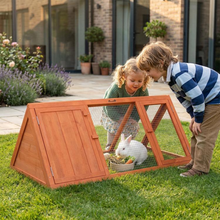 Wooden triangular rabbit hutch with open door and wire mesh, rabbit inside
