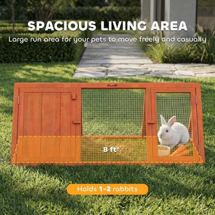 Wooden rabbit hutch run with wire mesh double doors and rabbit inside grass