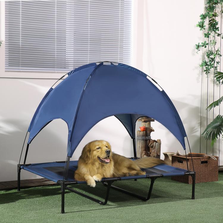 Dark blue dog cot with canopy over raised bed and black metal frame
