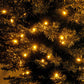 Artificial pencil Christmas tree with warm white LEDs; close-up of dark branches