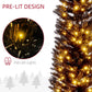 Close-up of glowing warm white LEDs on dark pencil tree branches