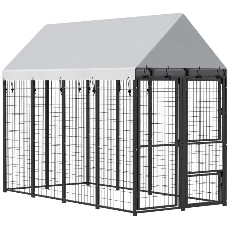 Large outdoor dog kennel with sloped roof, black frame, grated panels and side door