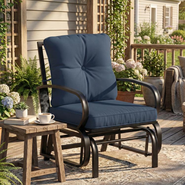 Dark blue cushioned patio glider chair with arched armrests and curved base