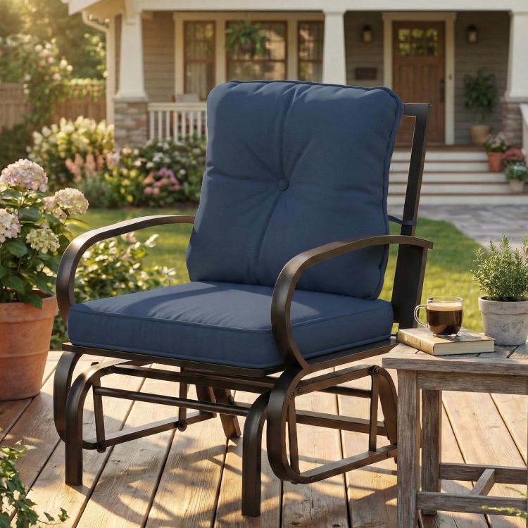 Dark blue patio glider chair with tufted back cushion and padded seat