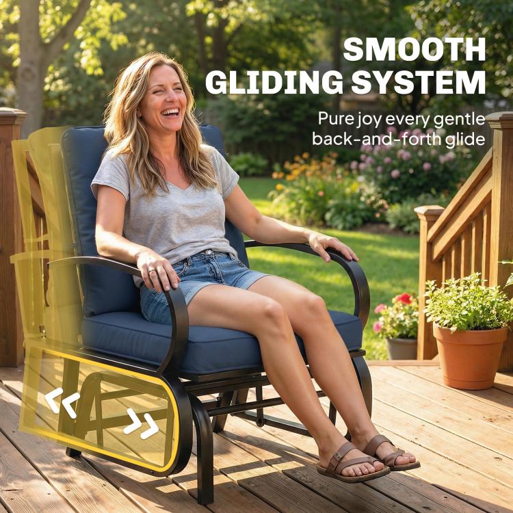 Dark blue cushioned patio glider chair with curved armrests shown outdoors in use