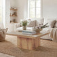 Light brown square coffee table with flowers and stacked books on the tabletop