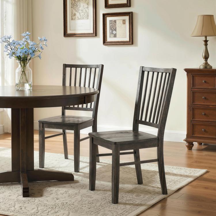 Charcoal gray armless dining chairs with vertical slat backs and solid wood legs