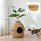 Rattan-style cat litter box enclosure with faux plant top and round front entry