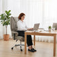Light gray high-back office chair with padded armrests on caster base for desk use