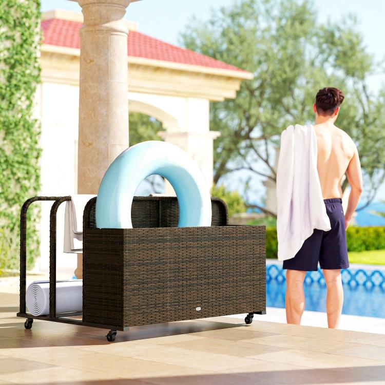Rattan pool float storage organizer with wheels holding a light blue pool float ring