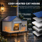 Weatherproof heated cat house with blue roof and orange glow through front window