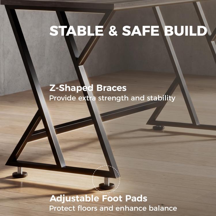 Close-up of Z-shaped metal braces under desk, distressed gray tabletop