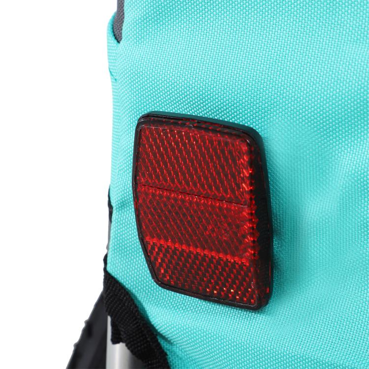 Green dog bike trailer side panel with red rear reflector and black trim