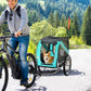 Green dog bike trailer with mesh cabin and orange flag, dog inside