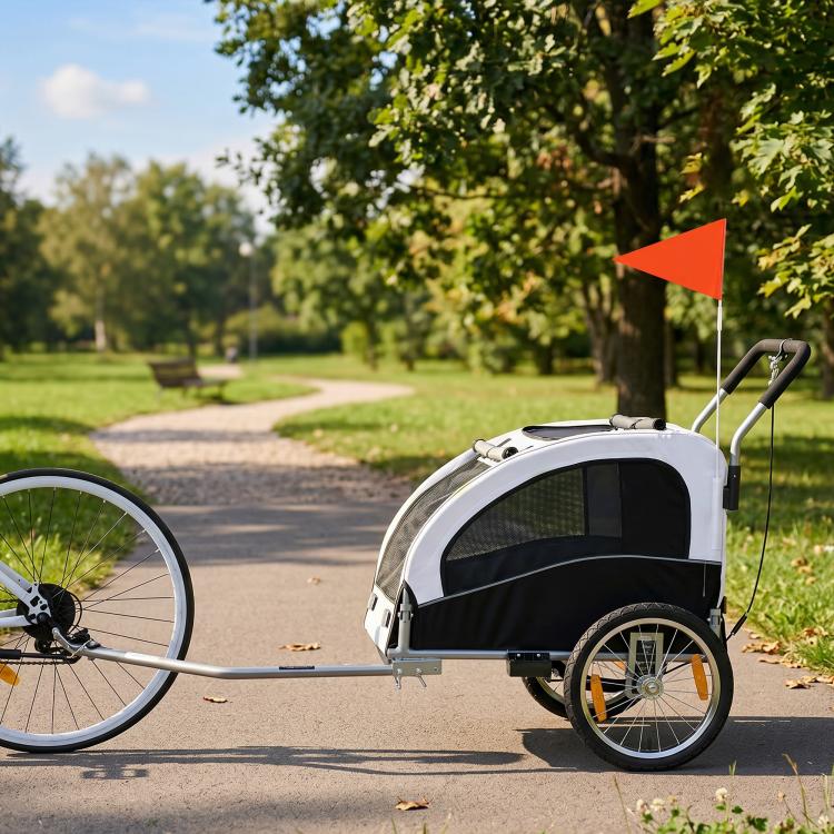 White foldable pet bike trailer with mesh front and large wheels, side view