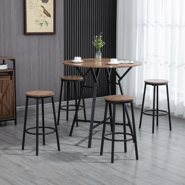 Bar height dining set: round table with four stools, black frames and wood-look tops.