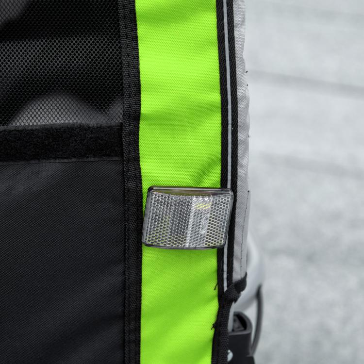 Green fabric and black mesh trailer side panel with zipper pocket