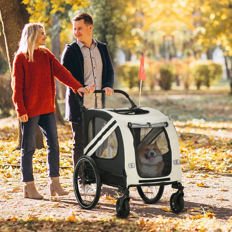 White and black pet bike trailer with front mesh door, canopy top, and safety flag