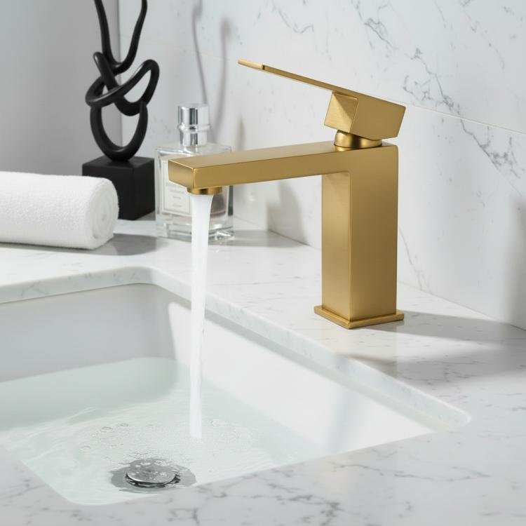 Brushed gold single-handle bathroom faucet with water stream on sink.