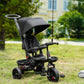 Black foldable tricycle with canopy, parent handle, and wheel brakes