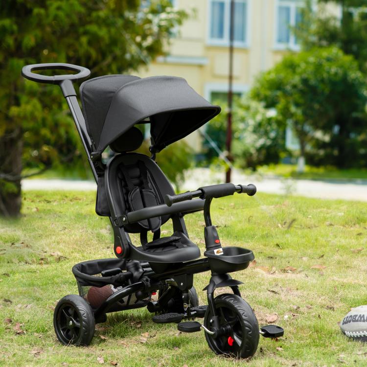 Black foldable tricycle with canopy, parent handle, and wheel brakes