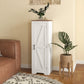 White floor storage cabinet with barn door, dark handle, and recessed panel detailing.