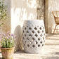 White ceramic garden stool featuring glazed lattice cutouts and a perforated top.