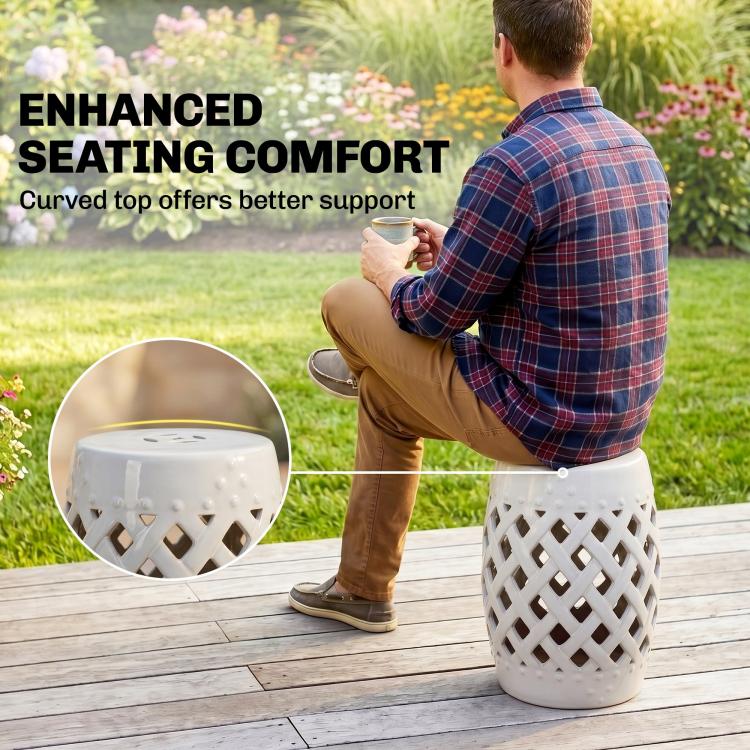 White ceramic lattice garden stool with perforated top on outdoor decking.